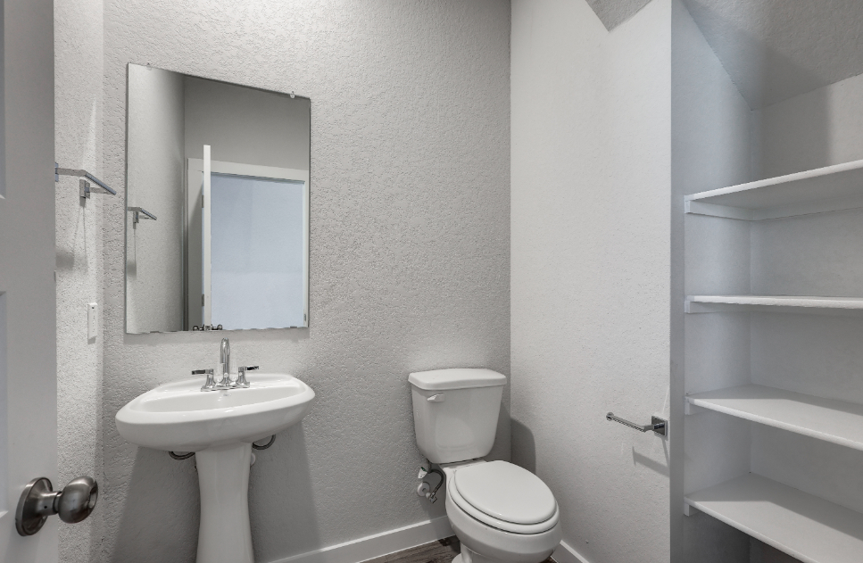 A bathroom with a toilet and sink.