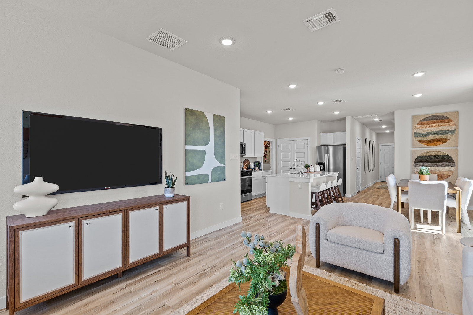 A living room with a tv and chairs.