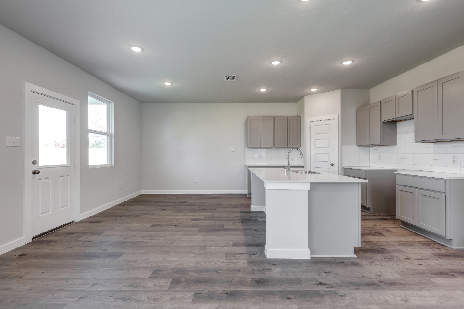 A kitchen with white cabinets.