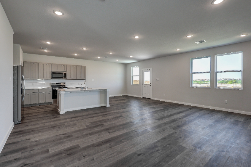 A large kitchen with wooden floors.