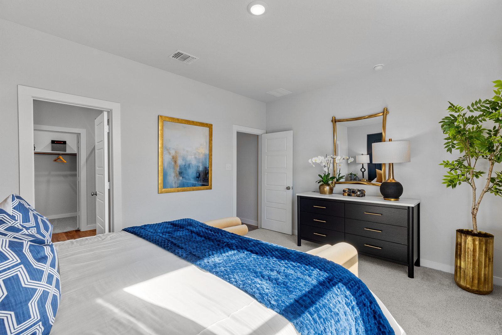 A bedroom with a bed and a dresser.