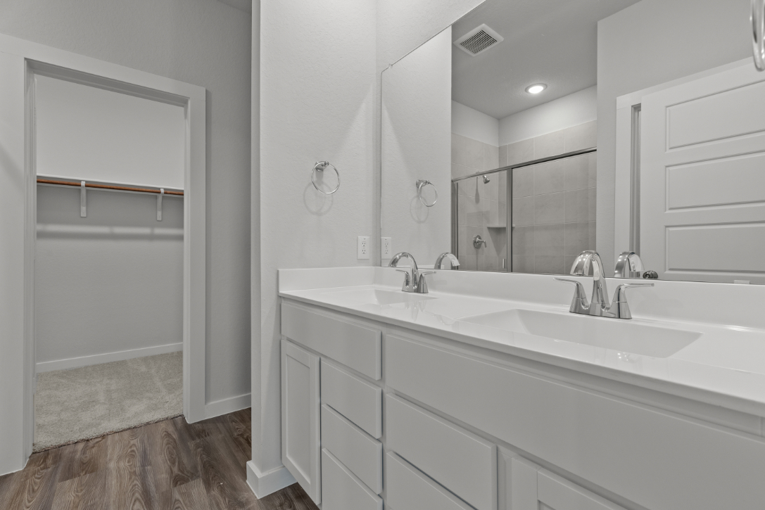 A bathroom with a large mirror.