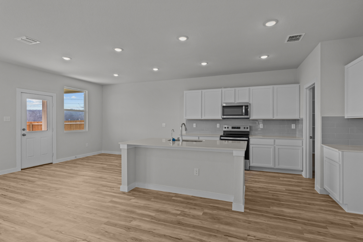 A kitchen with white cabinets.