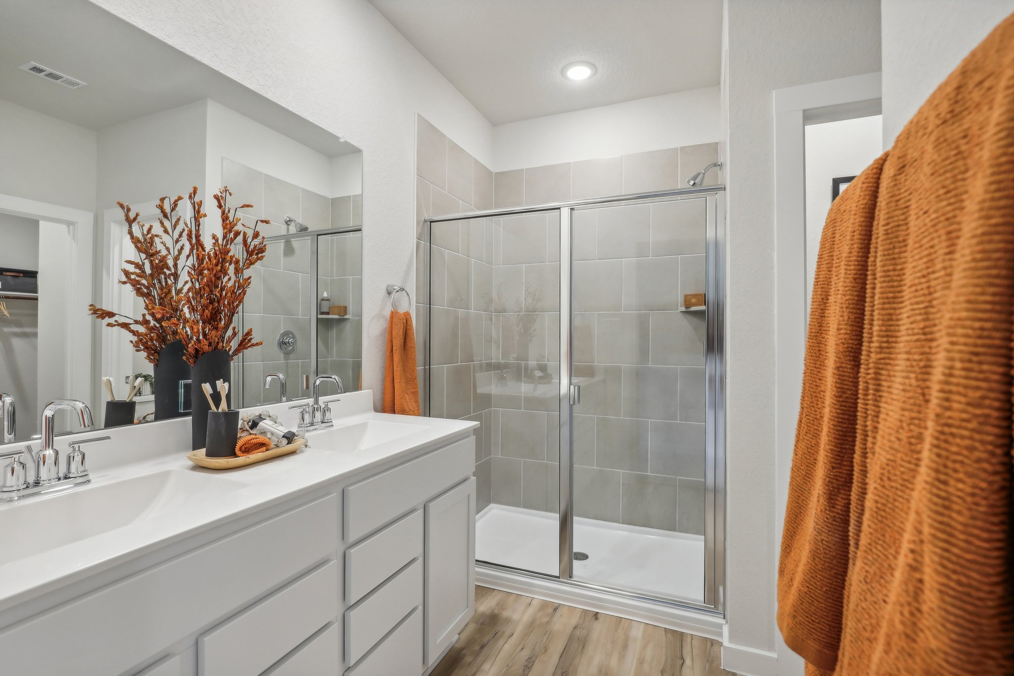 A bathroom with a shower and sink.
