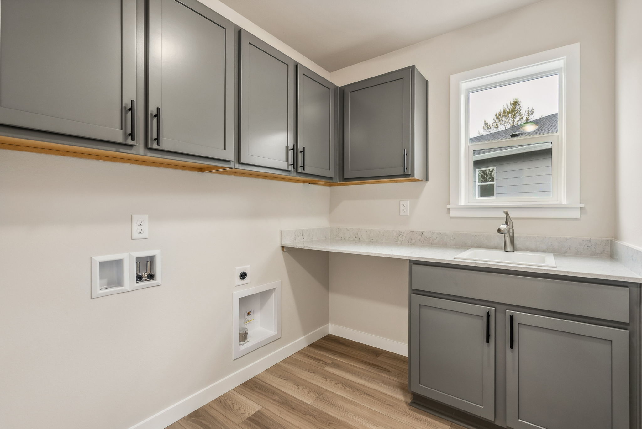 A kitchen with white cabinets.