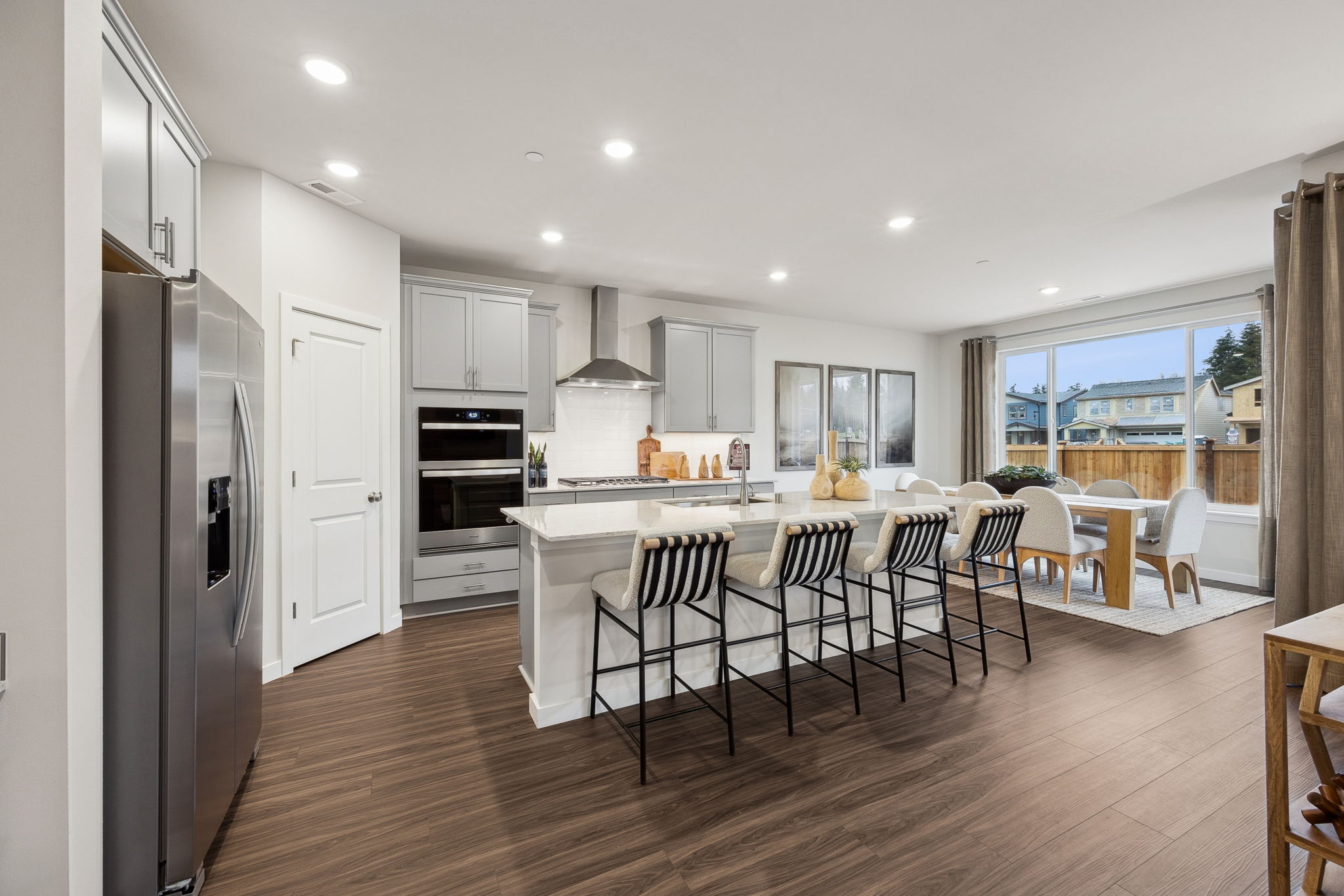 A kitchen with a dining table and chairs.