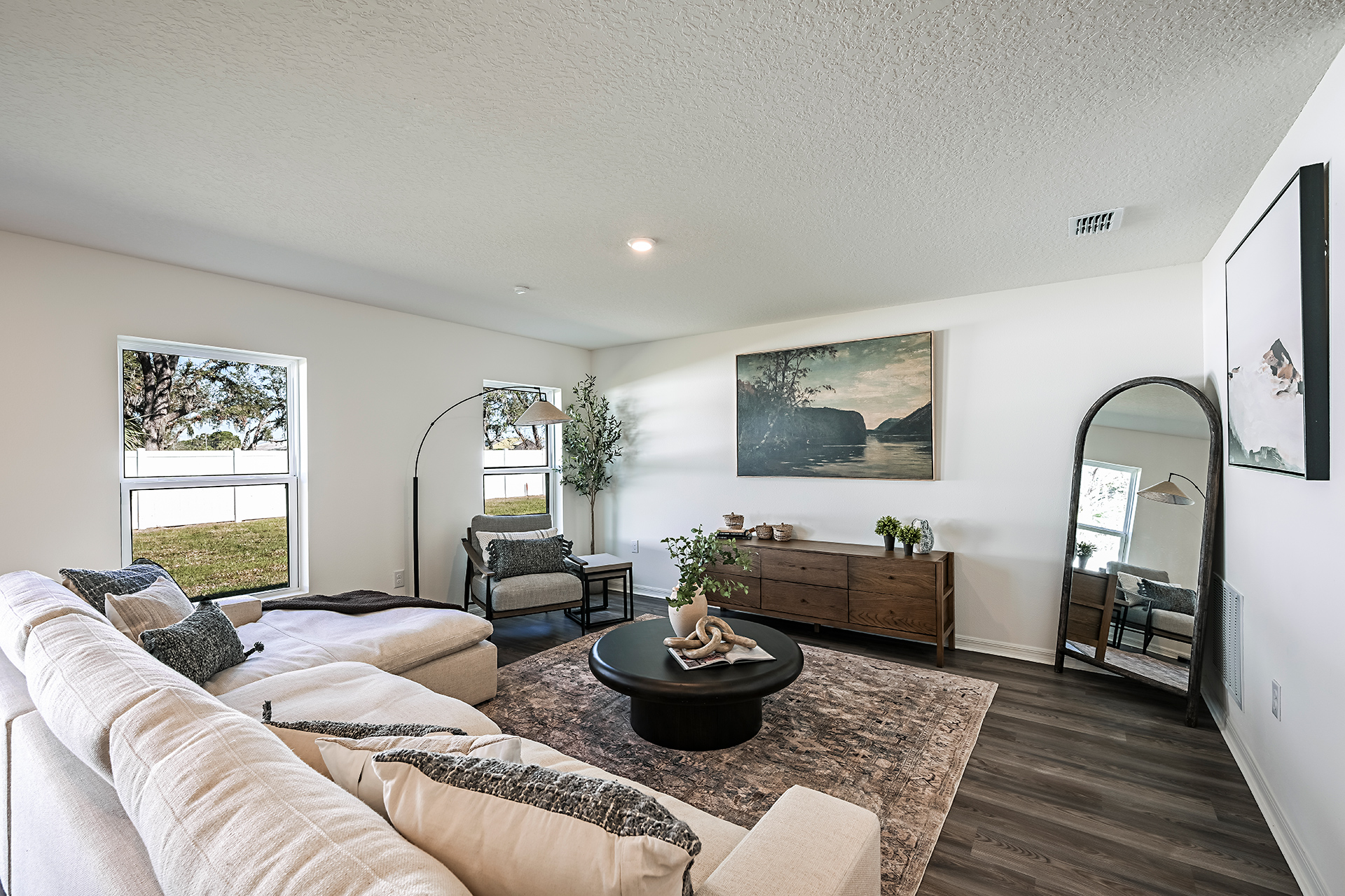 A living room with a large mirror.
