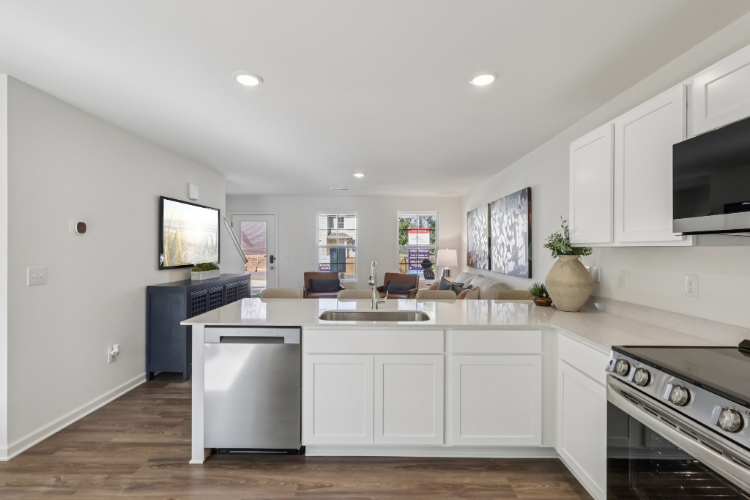 A kitchen with white cabinets.