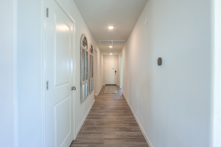 A hallway with white doors.