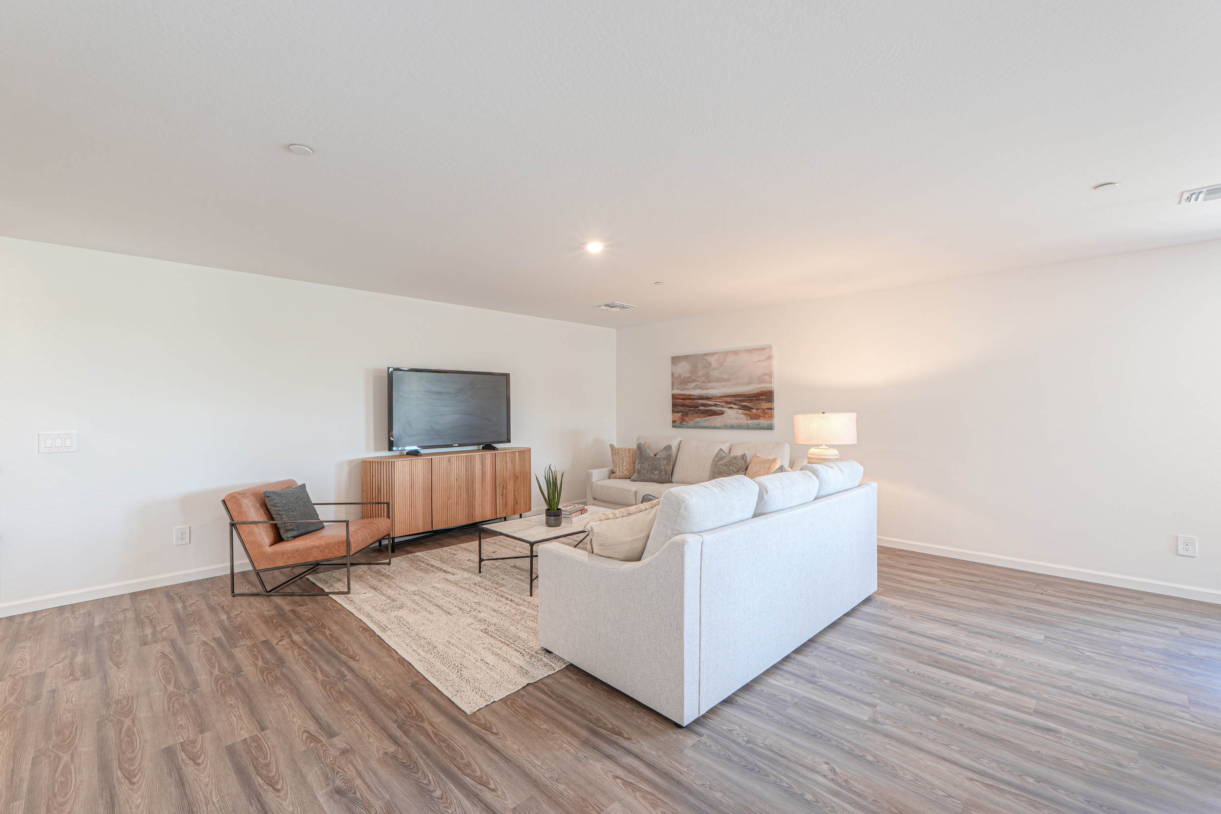 A living room with a large television.