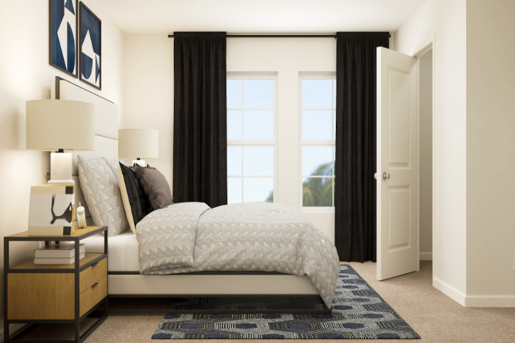 A bedroom with a large window.