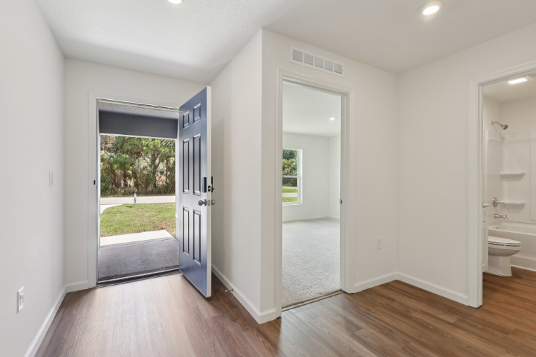 A bathroom with a glass door.