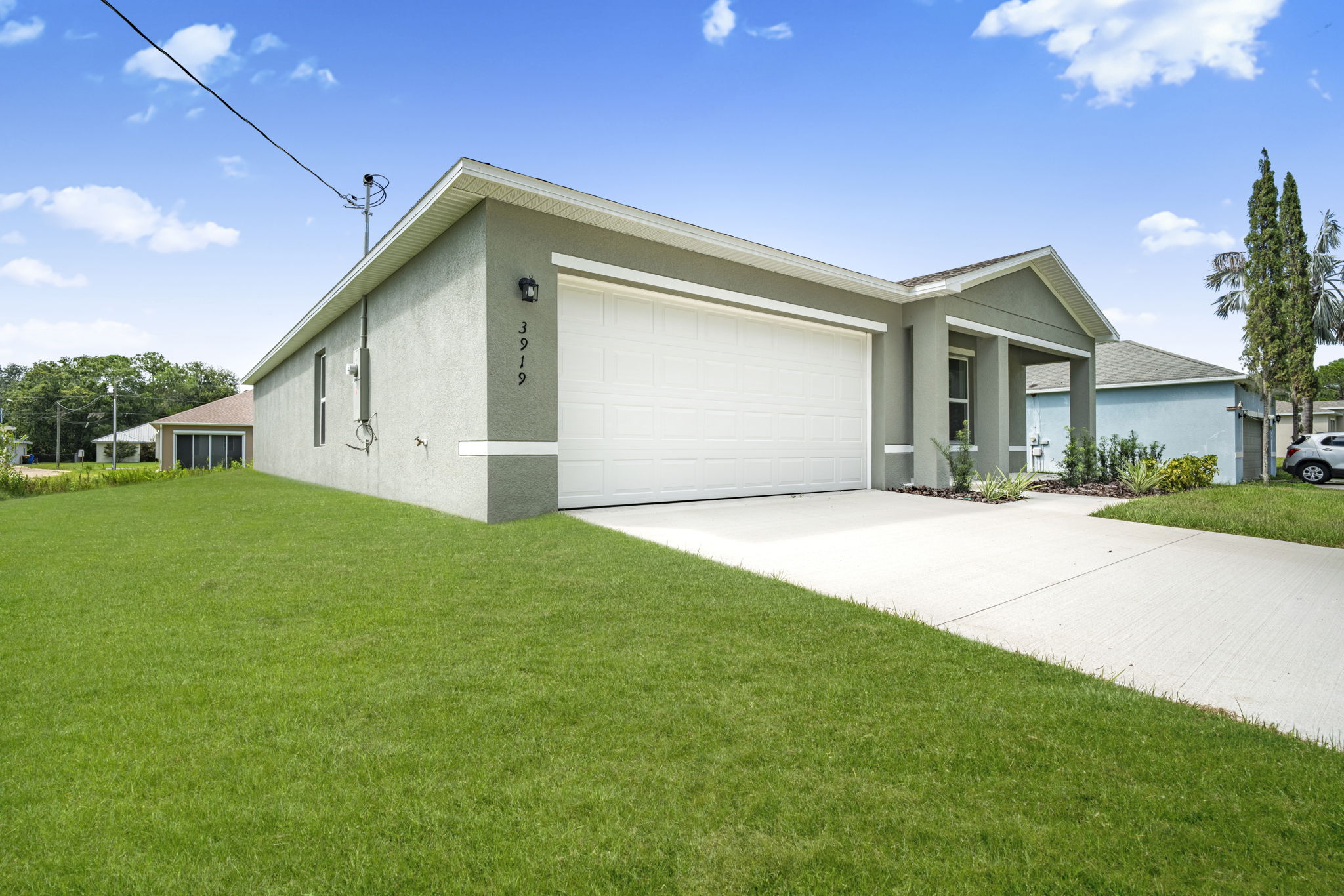 A white house with a driveway.