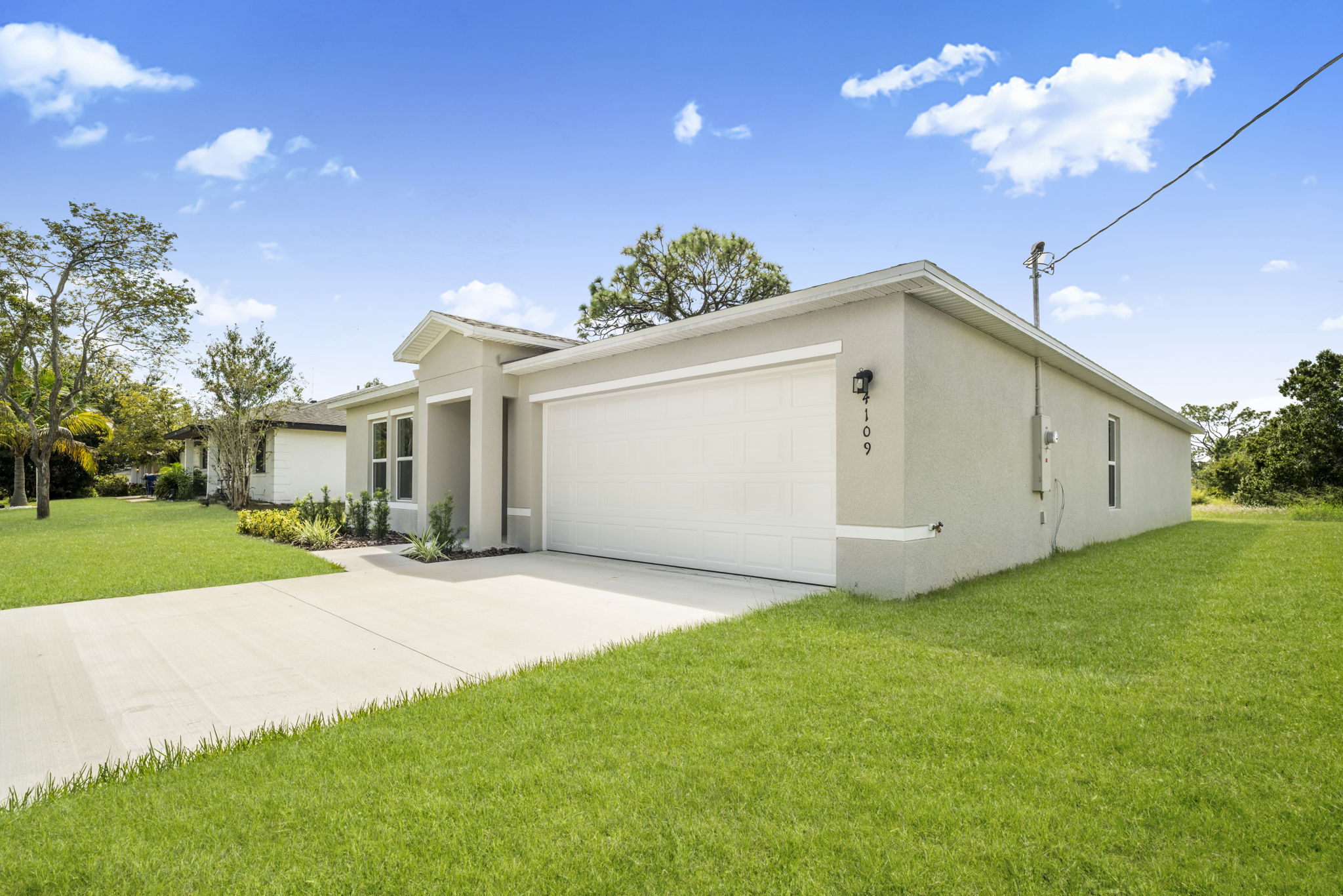 A white house with a driveway.