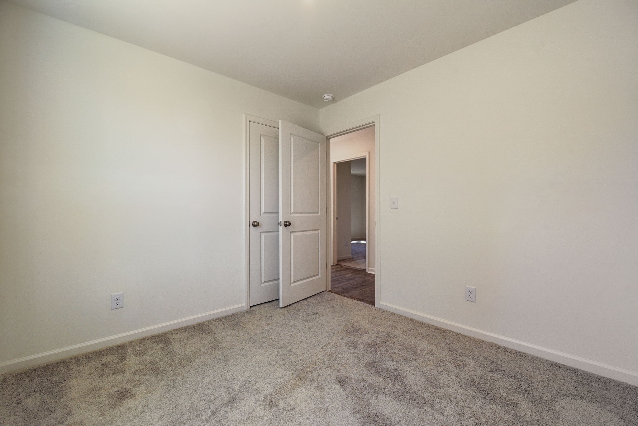 A hallway with white doors.