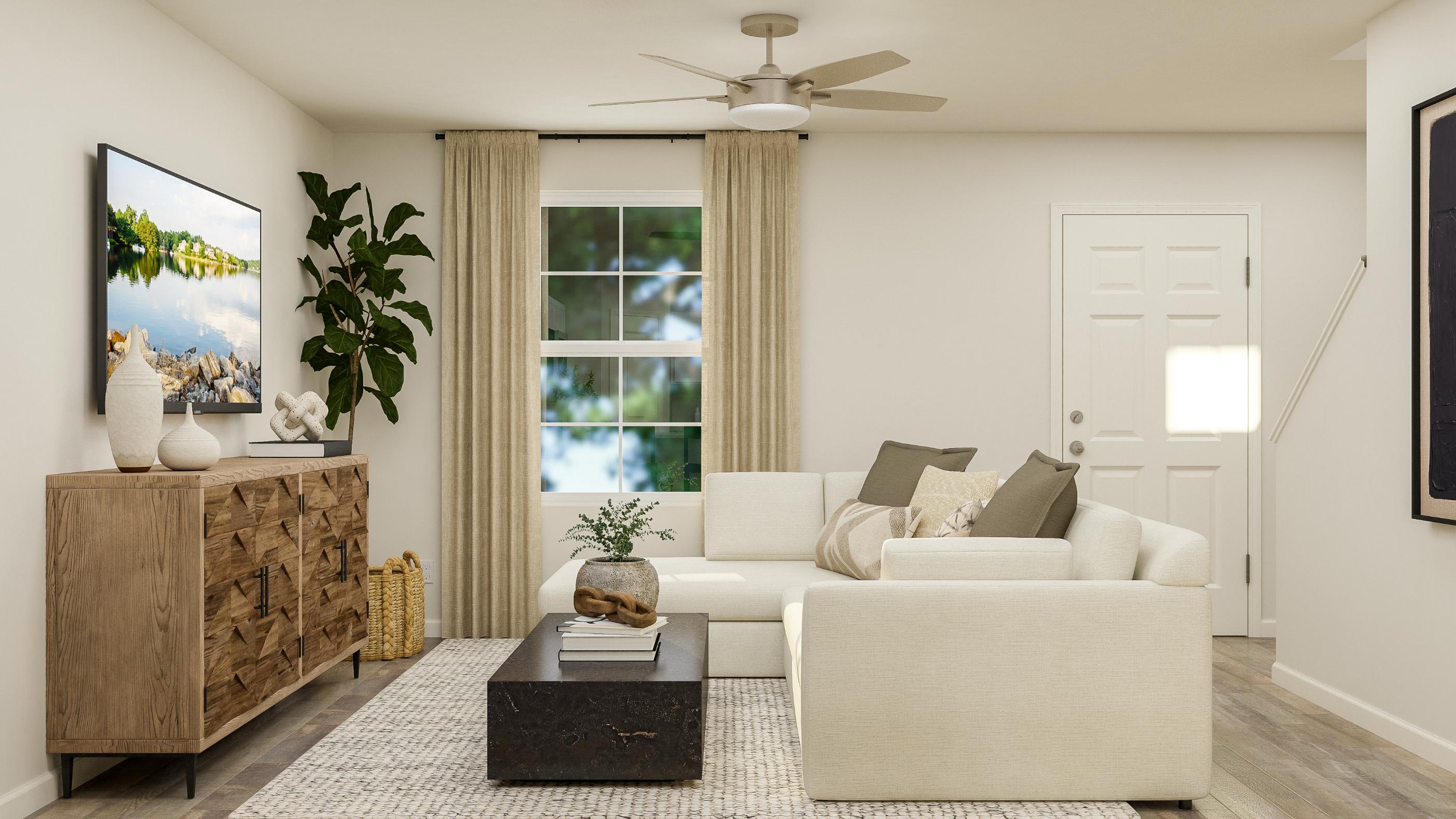 A living room with a white couch and a white door.