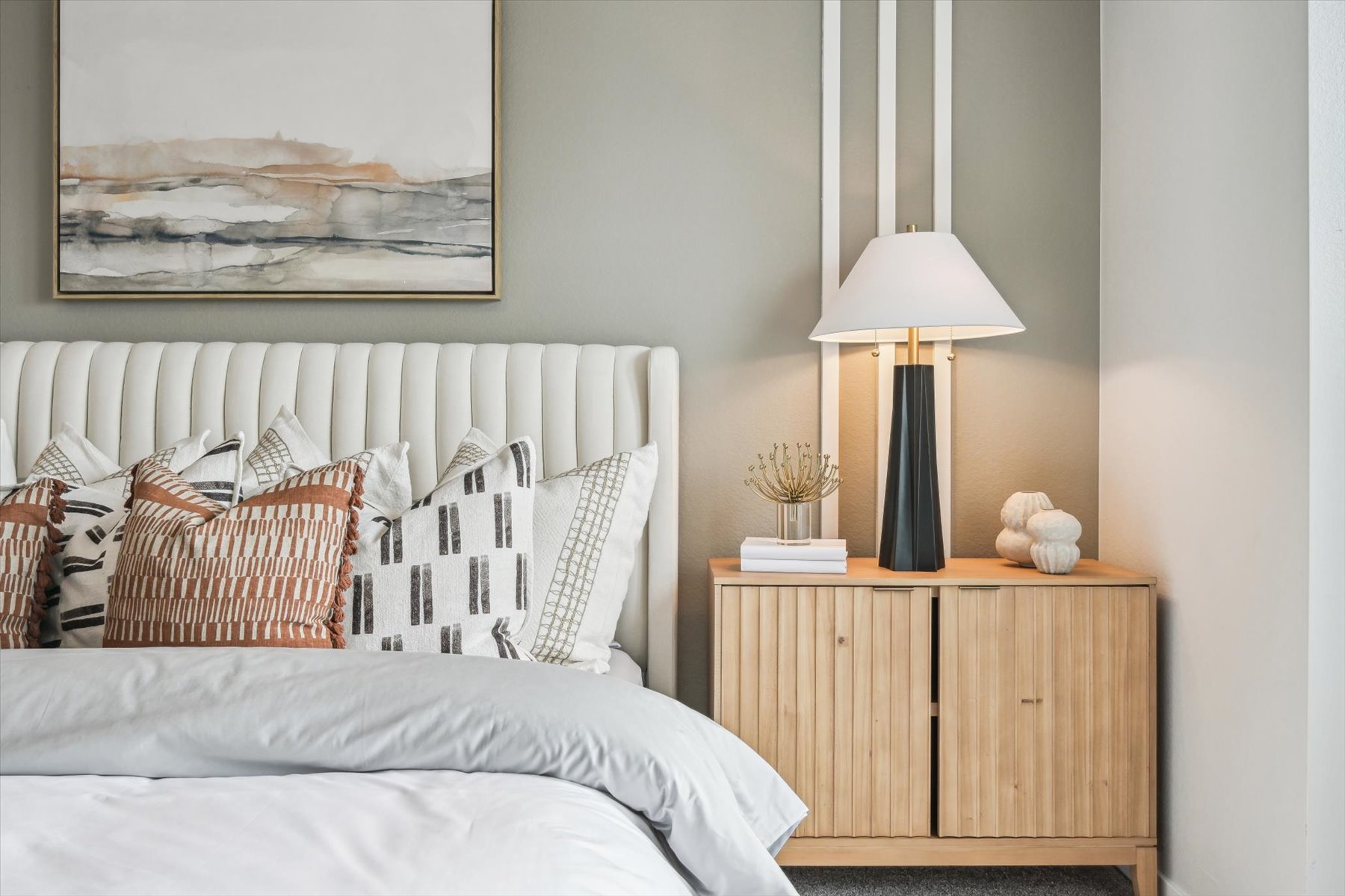 A bed with a lamp on the side.