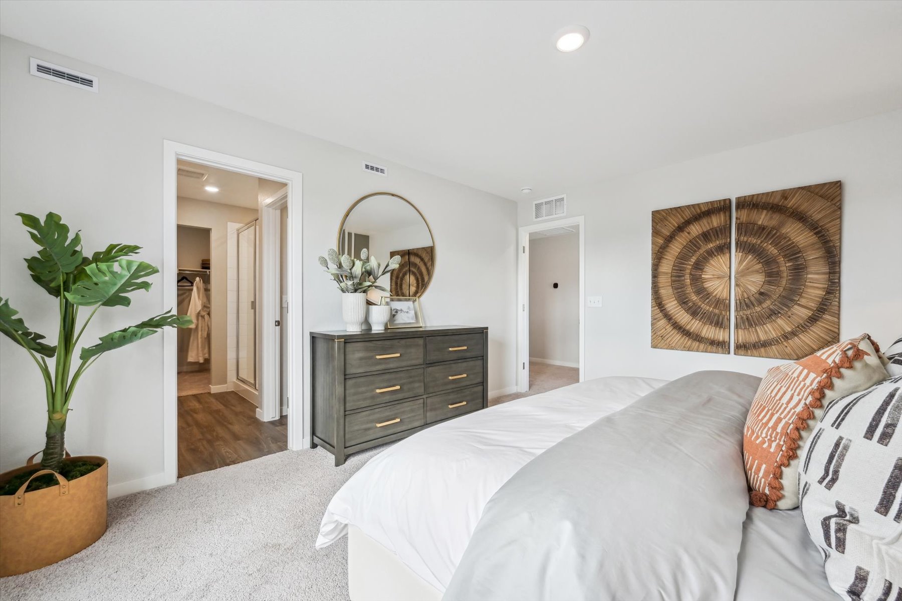 A bedroom with a bed and dresser.
